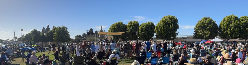 panoramic view of crowd around band on stage